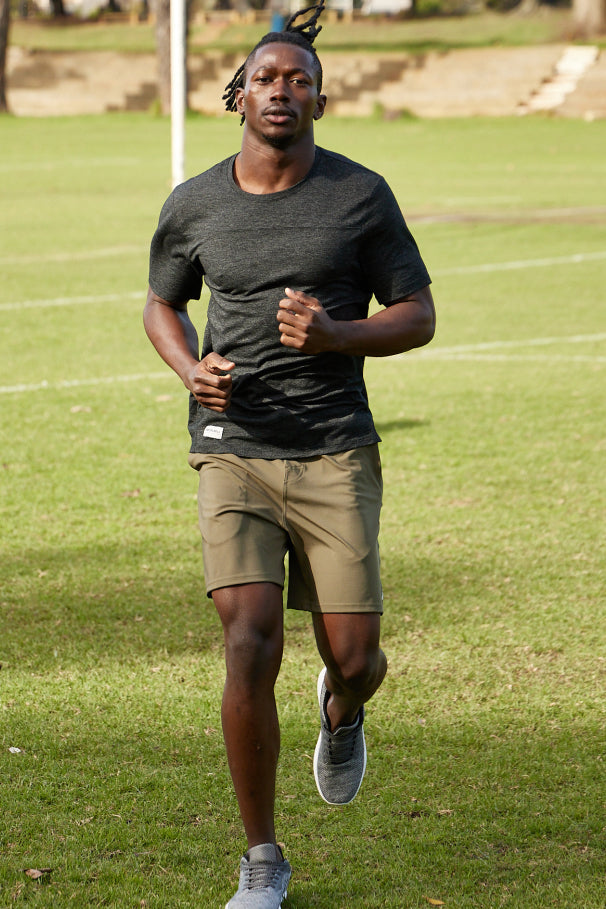 Running across a field dressed in Maru Clothing