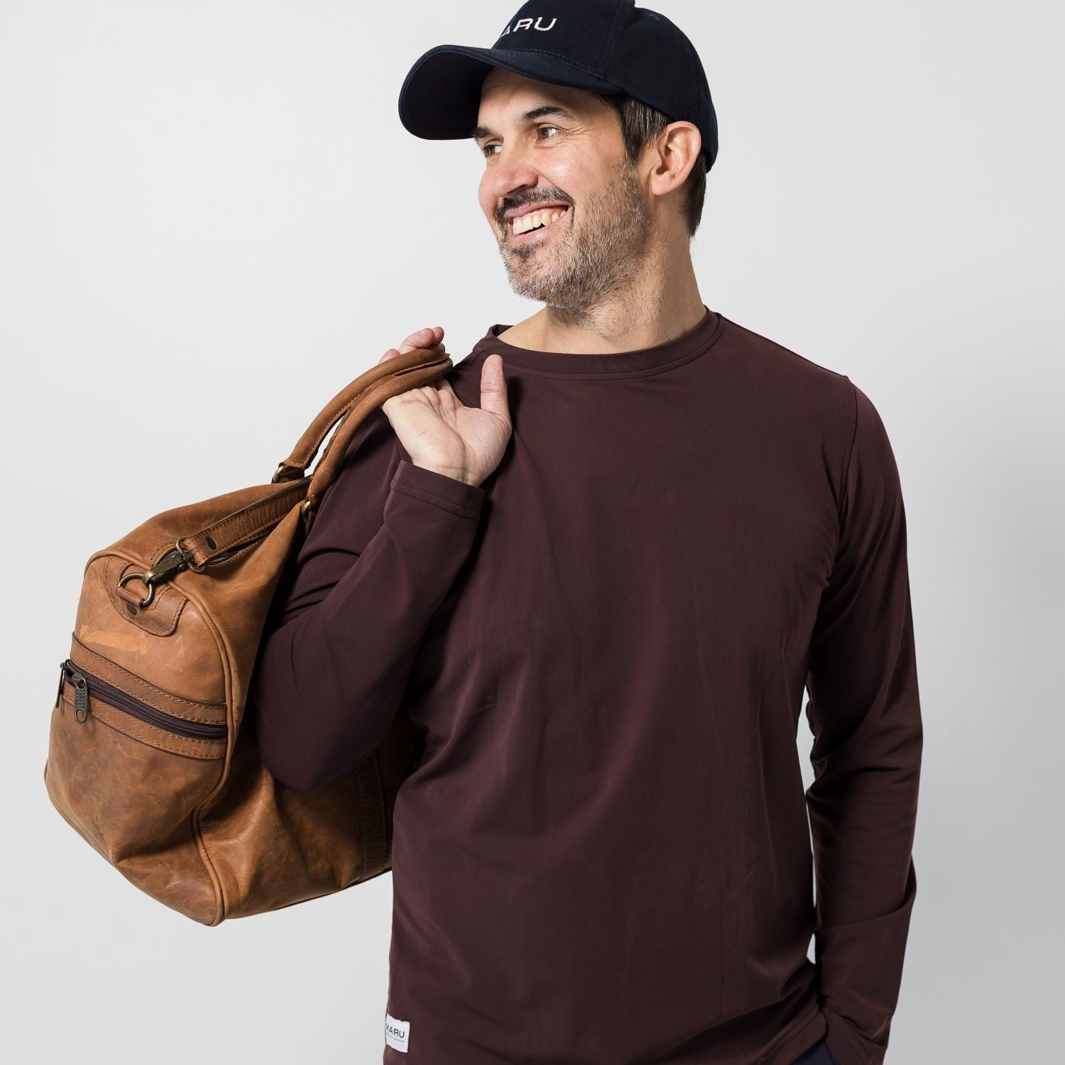 Man with bag over his shoulder wearing the Banker long sleeve T-shirt Maru Clothing 