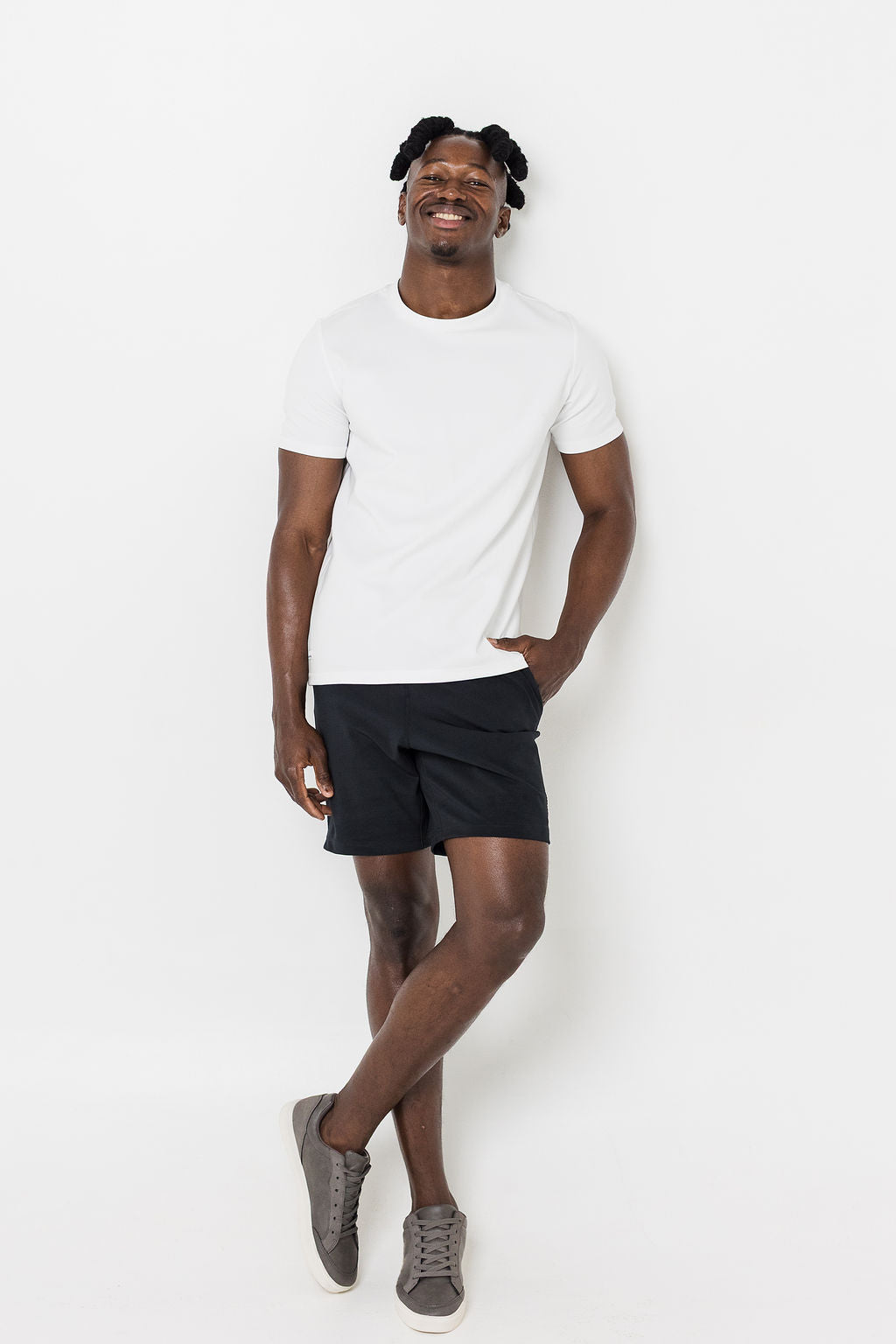 Man wearing black shorts and white t-shirt on a white background
